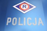 Napis &quot;POLICJA&quot; oraz logo ruchu drogowego