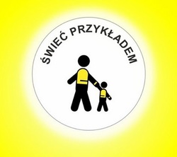 Na żółtym tle, w białym okręgu grafiki czarnych ludzików, którzy mają na sobie kamizelki odblaskowe. Nad nimi tekst: Świeć przykładem.