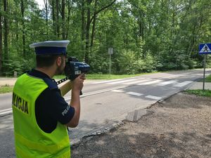 Policjant kontroluje prędkość pojazdów przy przejściu dla pieszych