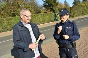 Policjantka oraz mężczyzna, który otrzymał odblaskową opaskę