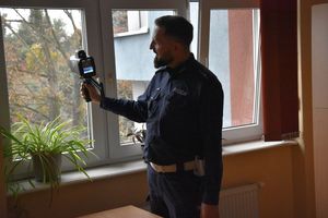 Zdjęcie przedstawia policjanta prezentującego sprzęt policyjny