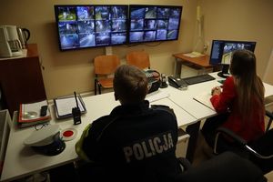 Zdjęcie przedstawia policjanta oraz operatorkę monitoringu miejskiego, którzy nadzorują ruch przy pomocy kamer