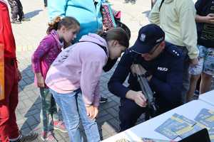 Zdjęcie przedstawia policjanta podczas prezentacji broni służbowej