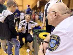 Zdjęcie przedstawia strażników miejskich podczas konkurencji przy koszach