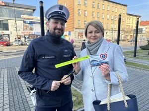 Zdjęcie przedstawia policjanta z kobietą