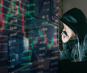 Mężczyzna z telefonem przy słupkach giełdowych